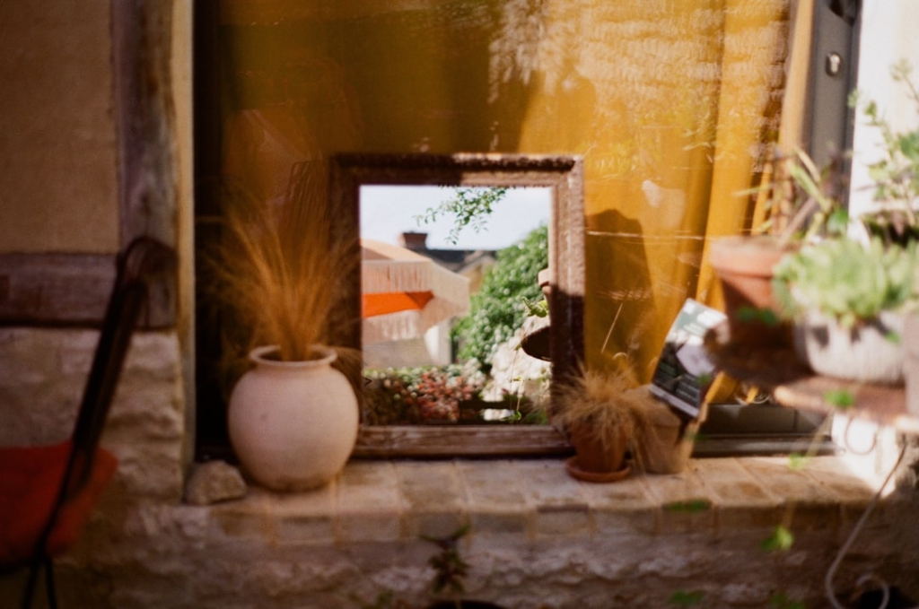 Photo Modern open-air photo booth, smiling guests, fairy lights, rustic Shropshire barn backdrop, instant prints in hand.