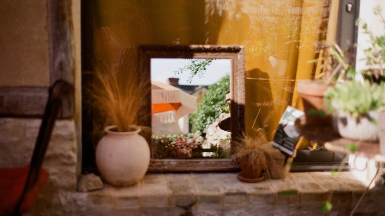 Photo Modern open-air photo booth, smiling guests, fairy lights, rustic Shropshire barn backdrop, instant prints in hand.